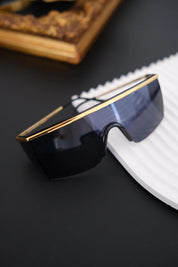 Vintage Gianni Versace MOD 790 shield sunglasses with dark blue panoramic lens and gold tone metal frame, made in Italy