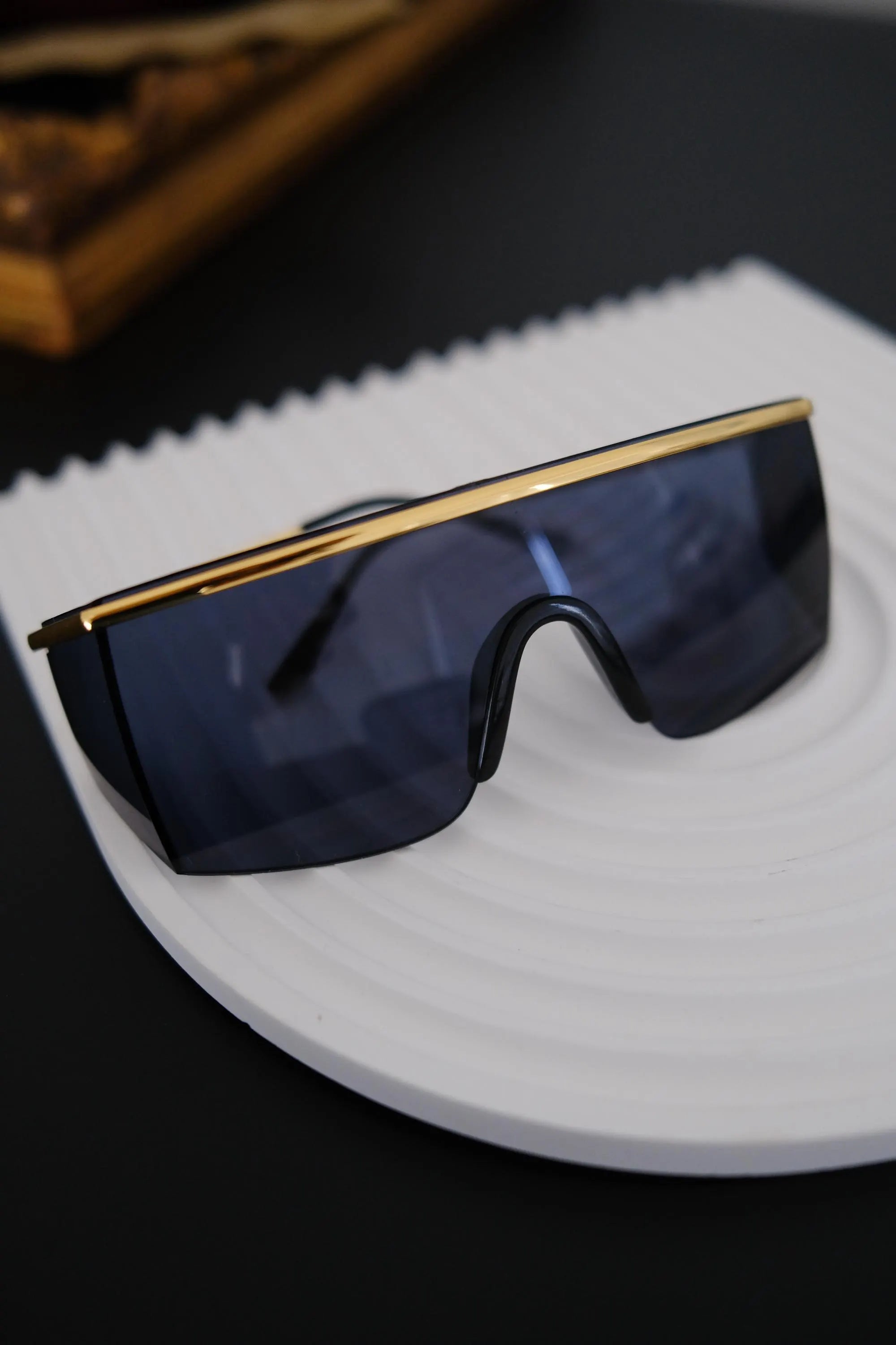 Side view of vintage Gianni Versace MOD 790 sunglasses showing gold tone temples and wraparound shield construction