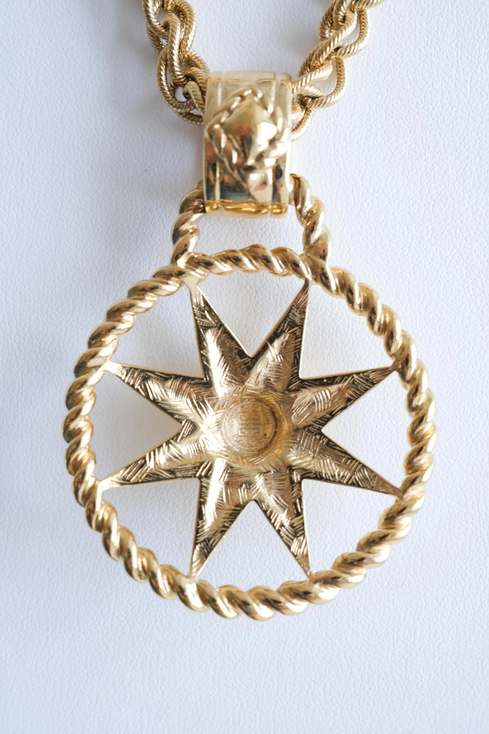Back view of Givenchy 4G pendant showing vintage epoxy detail and craftsmanship