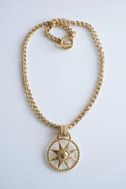 Vintage Givenchy gold 4G pendant necklace styled with a blazer for a sophisticated look