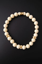Vintage Givenchy cream ivory beaded choker necklace with textured round beads and gold-tone accents
