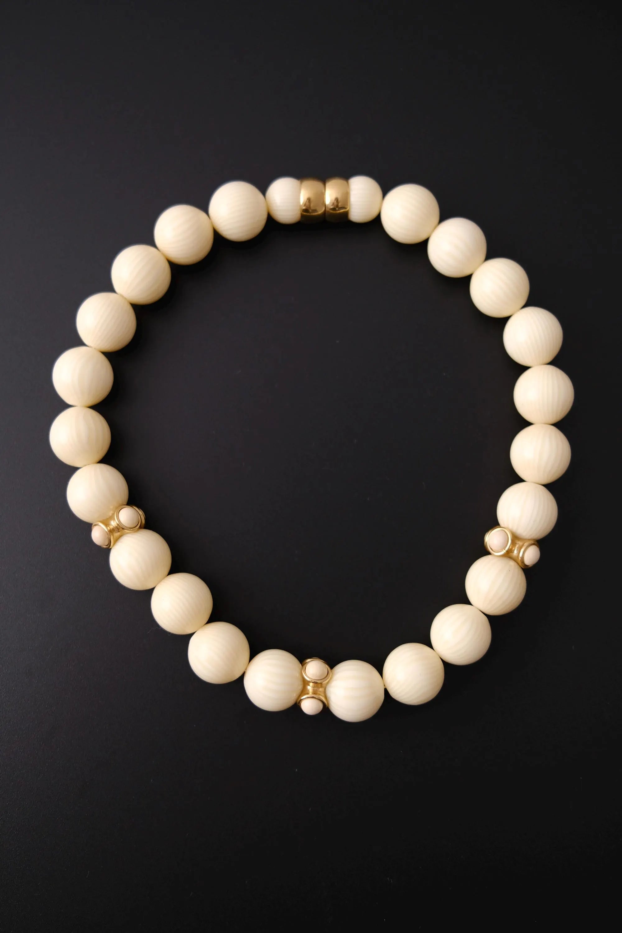 Vintage Givenchy cream ivory beaded choker necklace with textured round beads and gold-tone accents