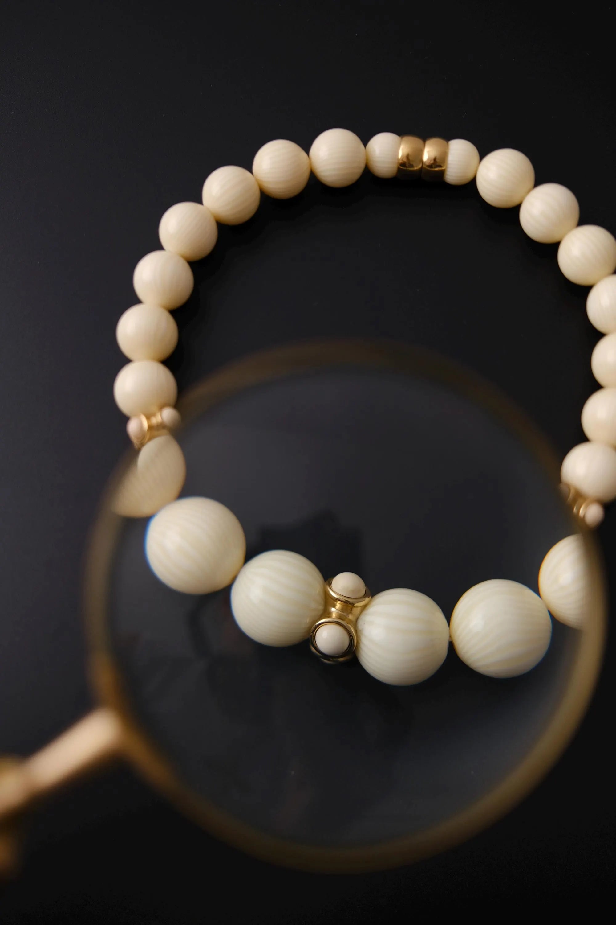 Graduated round cream-tone beads with textured surfaces on vintage Givenchy statement necklace