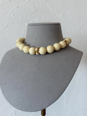 Excellent vintage condition Givenchy cream beaded necklace with bright gold-tone decorative accents