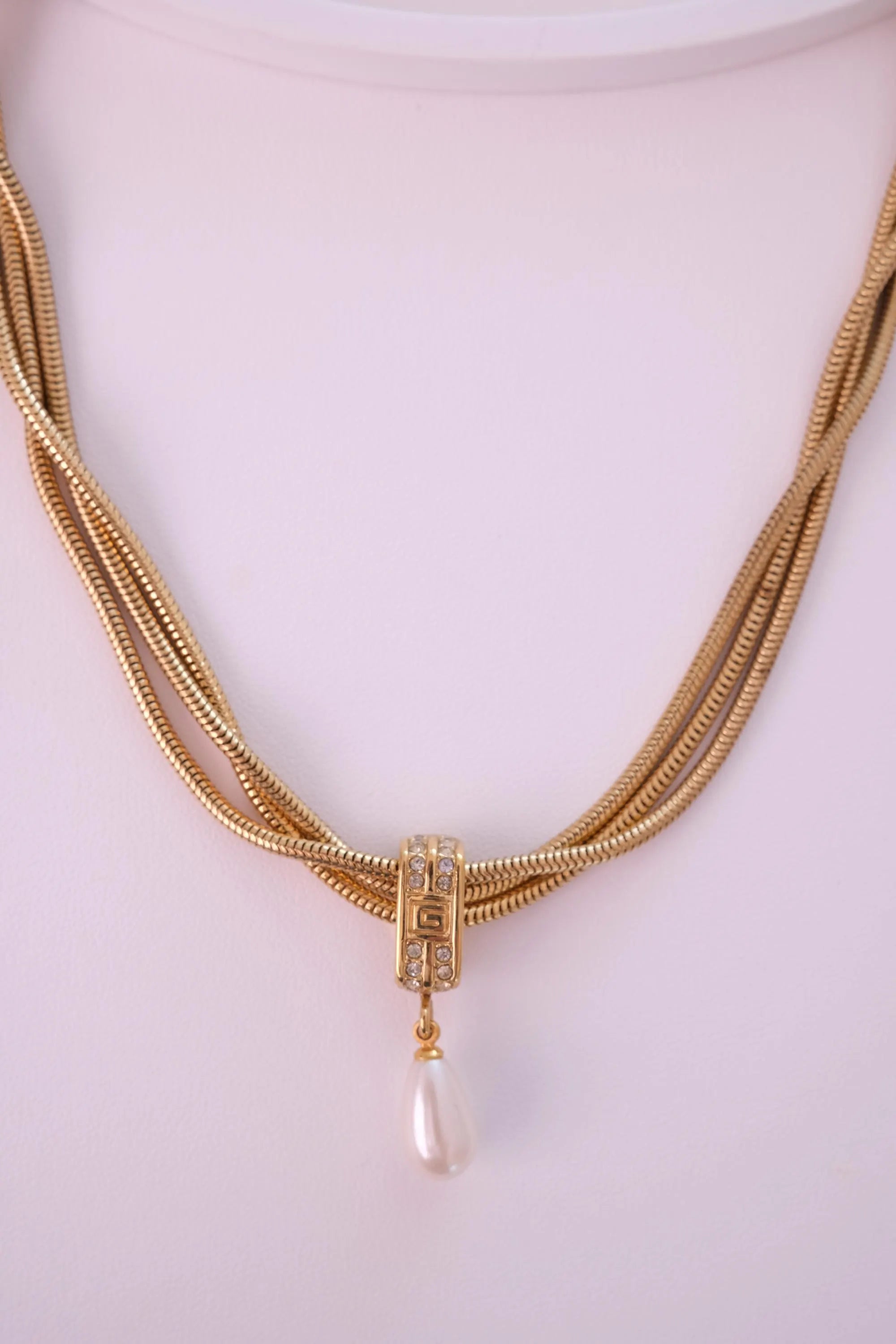 Vintage Givenchy necklace featuring luminous faux pearl drop and polished gold finish