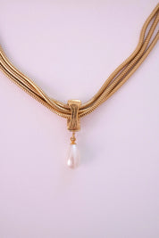 Vintage Givenchy necklace featuring luminous faux pearl drop and polished gold finish