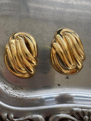 Givenchy gold knot earrings on ear refined timeless style for modern women