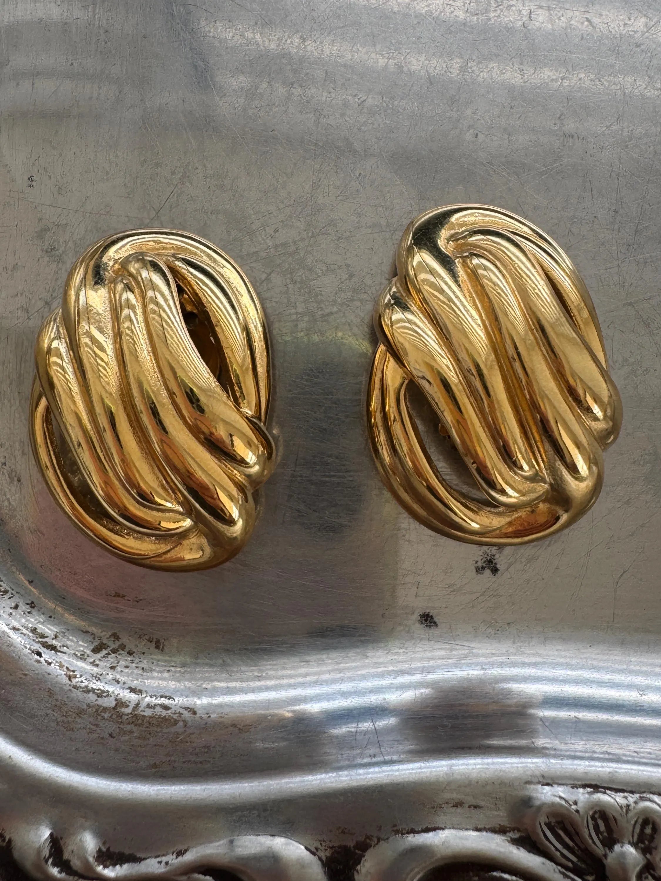 Givenchy gold knot earrings on ear refined timeless style for modern women