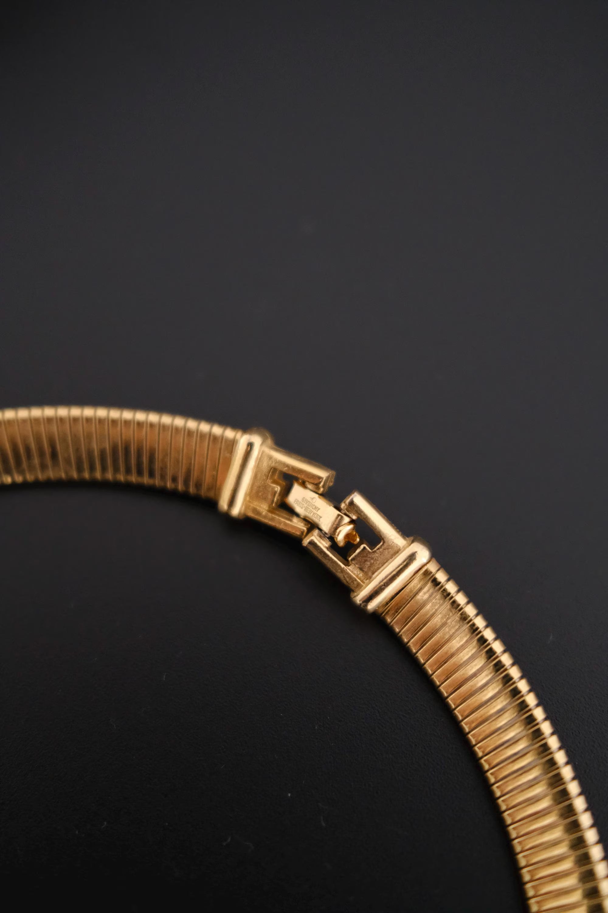 Close-up of a Vintage Givenchy gold-tone choker necklace with crystal-set geometric links 