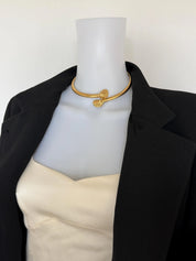 Givenchy vintage sculptural gold shell choker necklace styled with an elegant dress