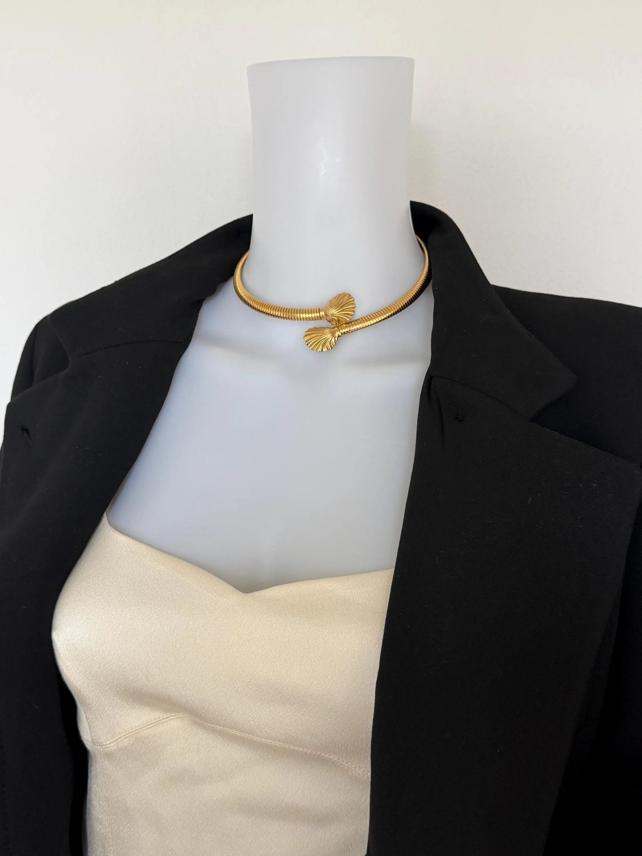 Givenchy vintage sculptural gold shell choker necklace styled with an elegant dress