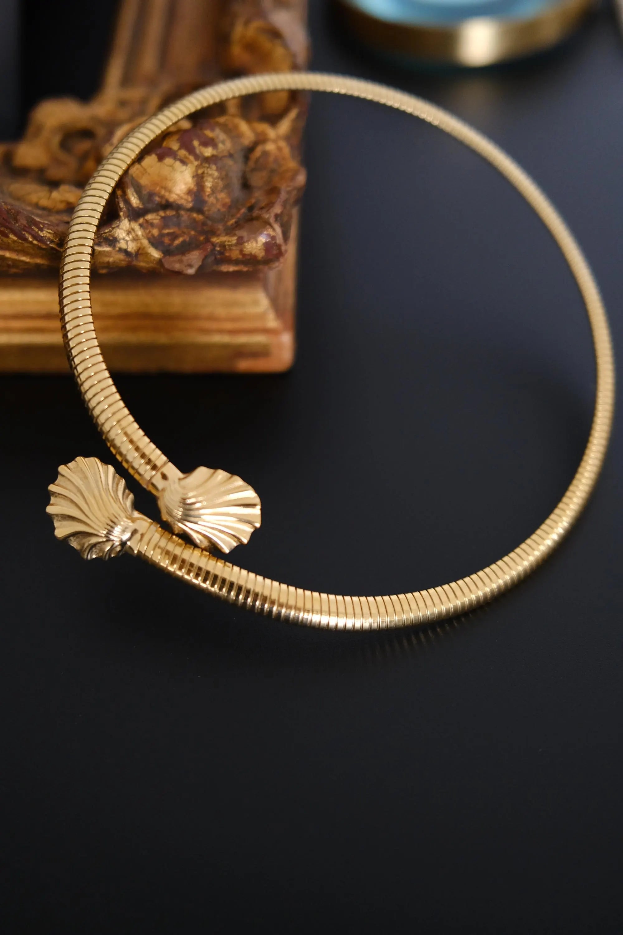 Full view of vintage Givenchy gold-tone articulated coil choker with two shell-shaped terminals
