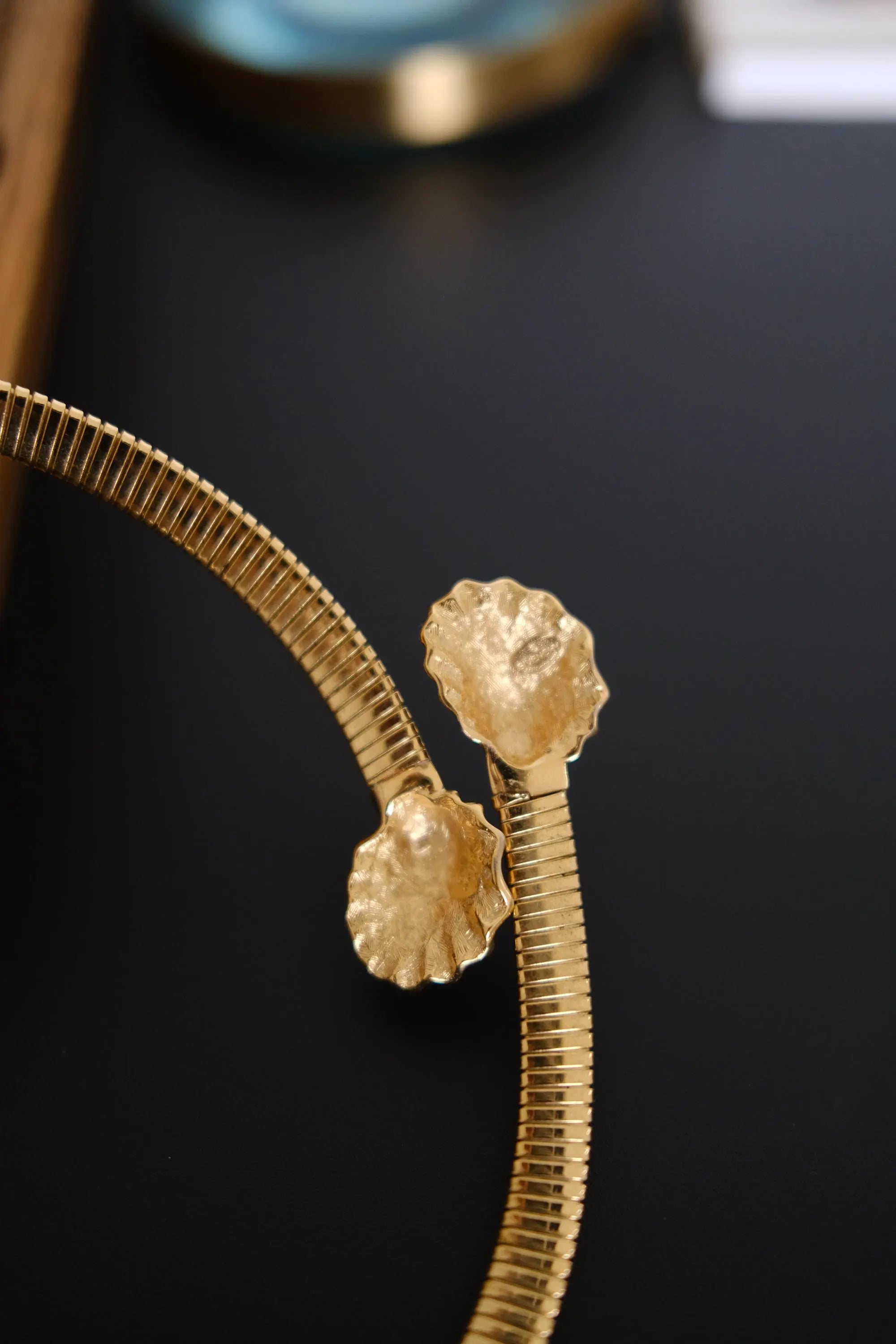 Close-up of sculptural fluted shell-shaped terminals on vintage Givenchy gold-tone choker