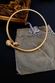 Full view of vintage Givenchy gold-tone articulated coil choker with two shell-shaped terminals