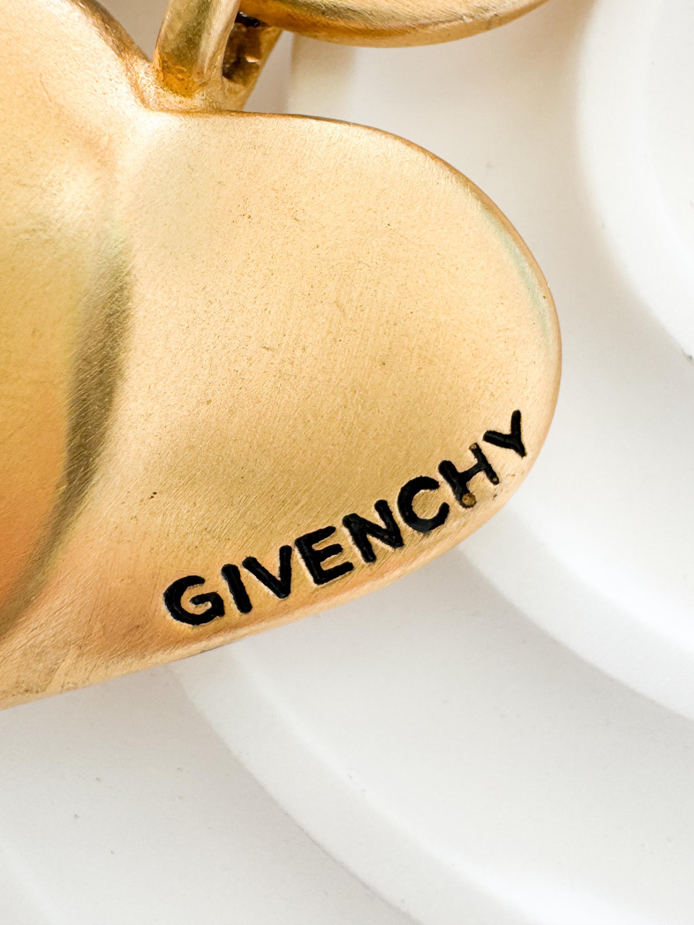 Vintage Givenchy Paris New York heart charm bracelet featuring a matte gold chunky chain, classic 1980s designer jewelry style, statement fashion accessory for women