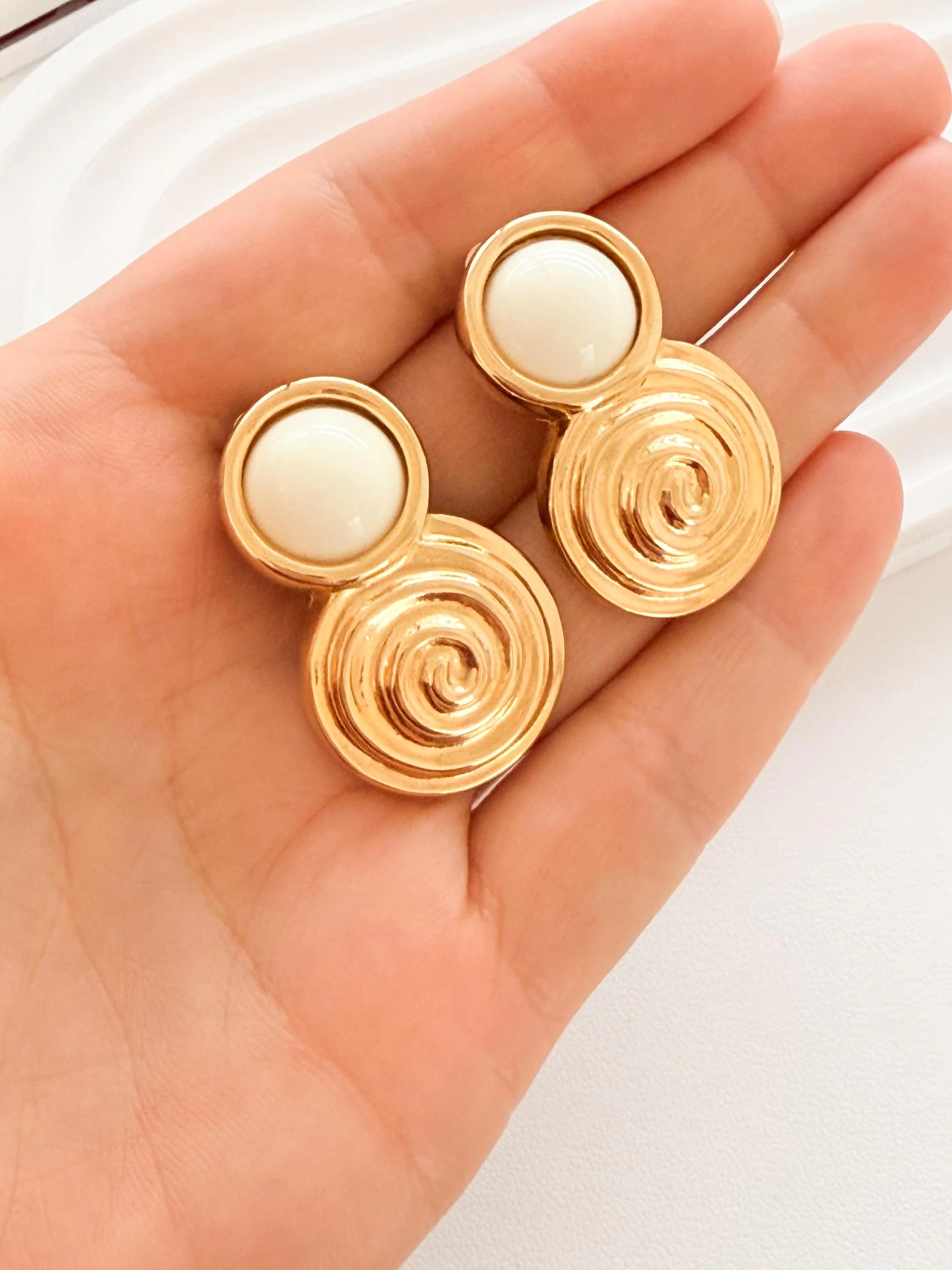 Givenchy pearl drop earrings side view graceful movement elegant design