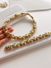 Gold choker necklace and faux pearl bracelet set coordinated luxury styling