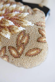 Detailed view of raised sculptural floral petals and dimensional beadwork on vintage Japanese evening handbag