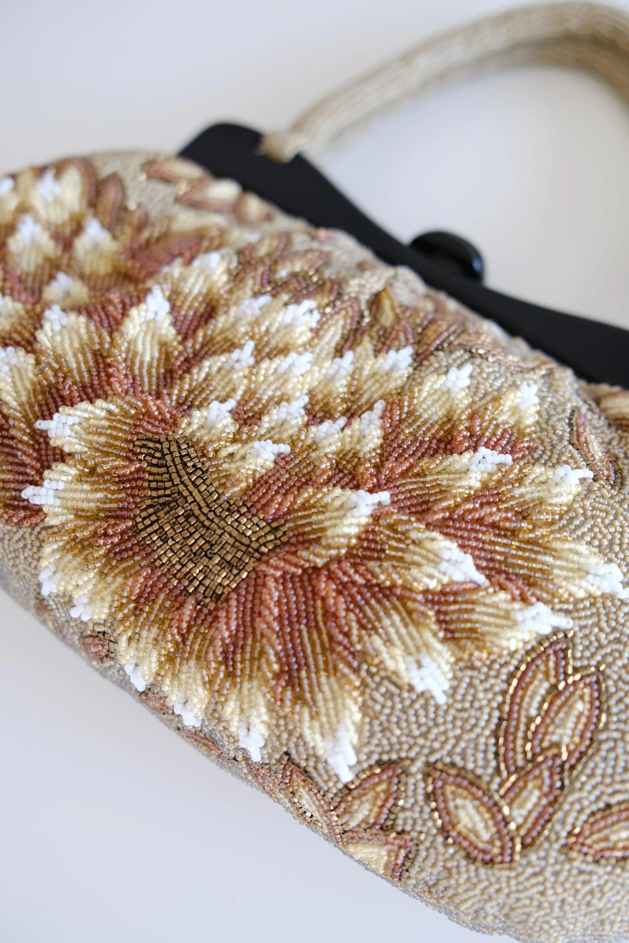 Detailed view of raised sculptural floral petals and dimensional beadwork on vintage Japanese evening handbag