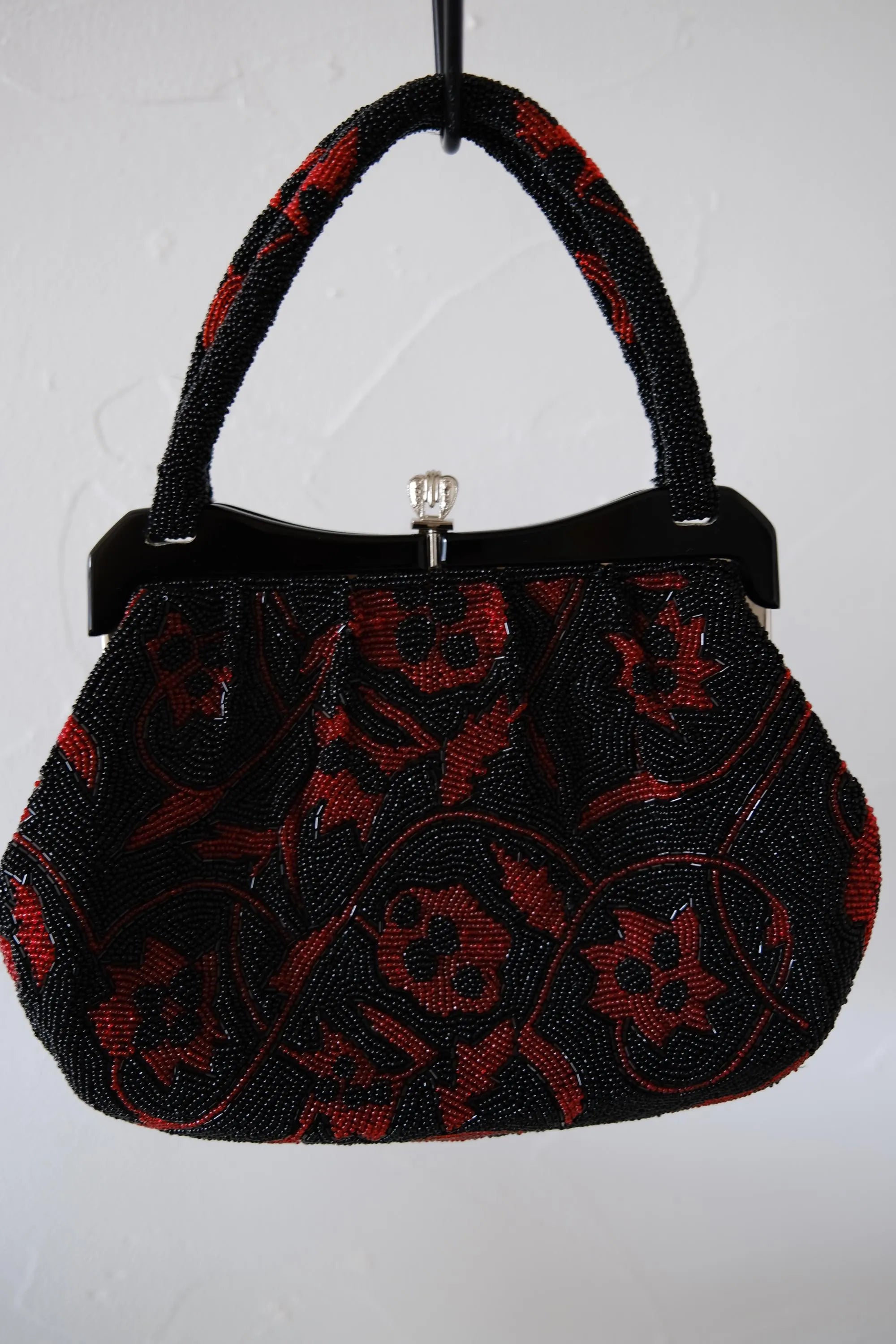 Vintage Japanese glass beaded evening handbag in black and deep red floral pattern with structured beaded handle and decorative clasp