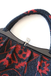 Close-up of decorative clasp closure and silver-tone metalwork on vintage Japanese beaded evening bag