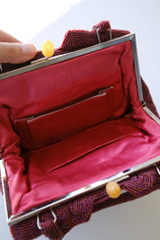 Interior view of vintage Japanese beaded handbag featuring rich red silk lining and storage pockets