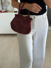 Vintage Japanese burgundy floral glass beaded handbag carried by its double structured beaded handles