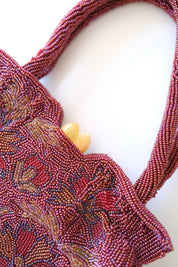 Close-up of intricate Japanese glass seed bead and bugle bead embroidery in burgundy, blue, gold and green
