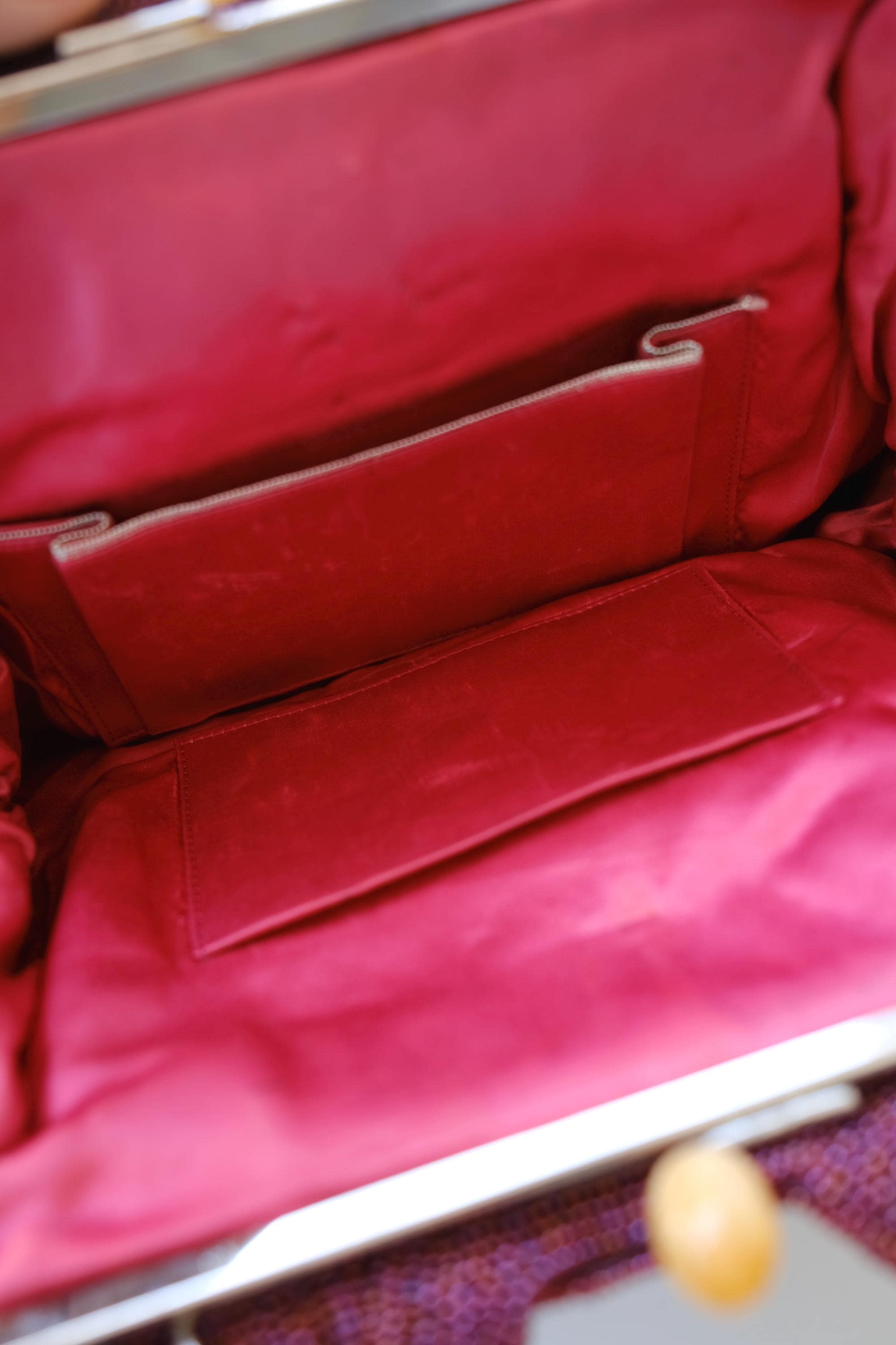 Close-up of interior storage pockets inside vintage Japanese burgundy glass beaded handbag