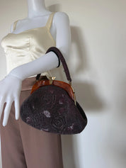 Vintage Japanese purple floral glass beaded handbag carried by its structured beaded top handle