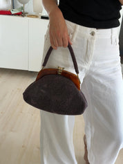 Vintage Japanese purple floral glass beaded handbag carried by its structured beaded top handle