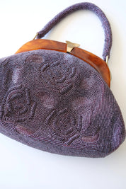 Close-up of dimensional 3D rose floral embroidery made with tiny purple glass seed and bugle beads