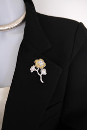 Very good vintage condition KENZO flower brooch showing silver and champagne gold tone finish and blue crystal accents