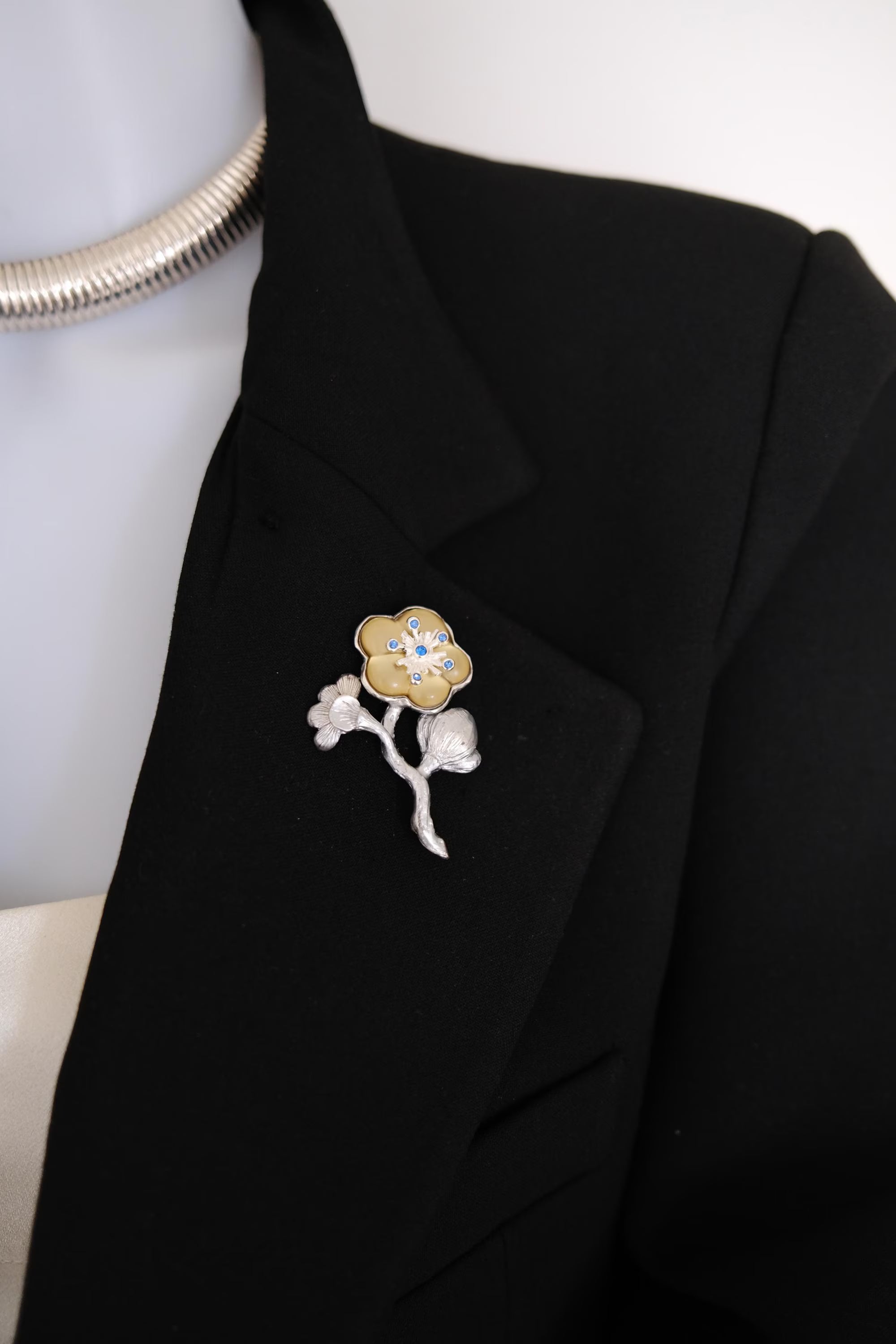 Very good vintage condition KENZO flower brooch showing silver and champagne gold tone finish and blue crystal accents