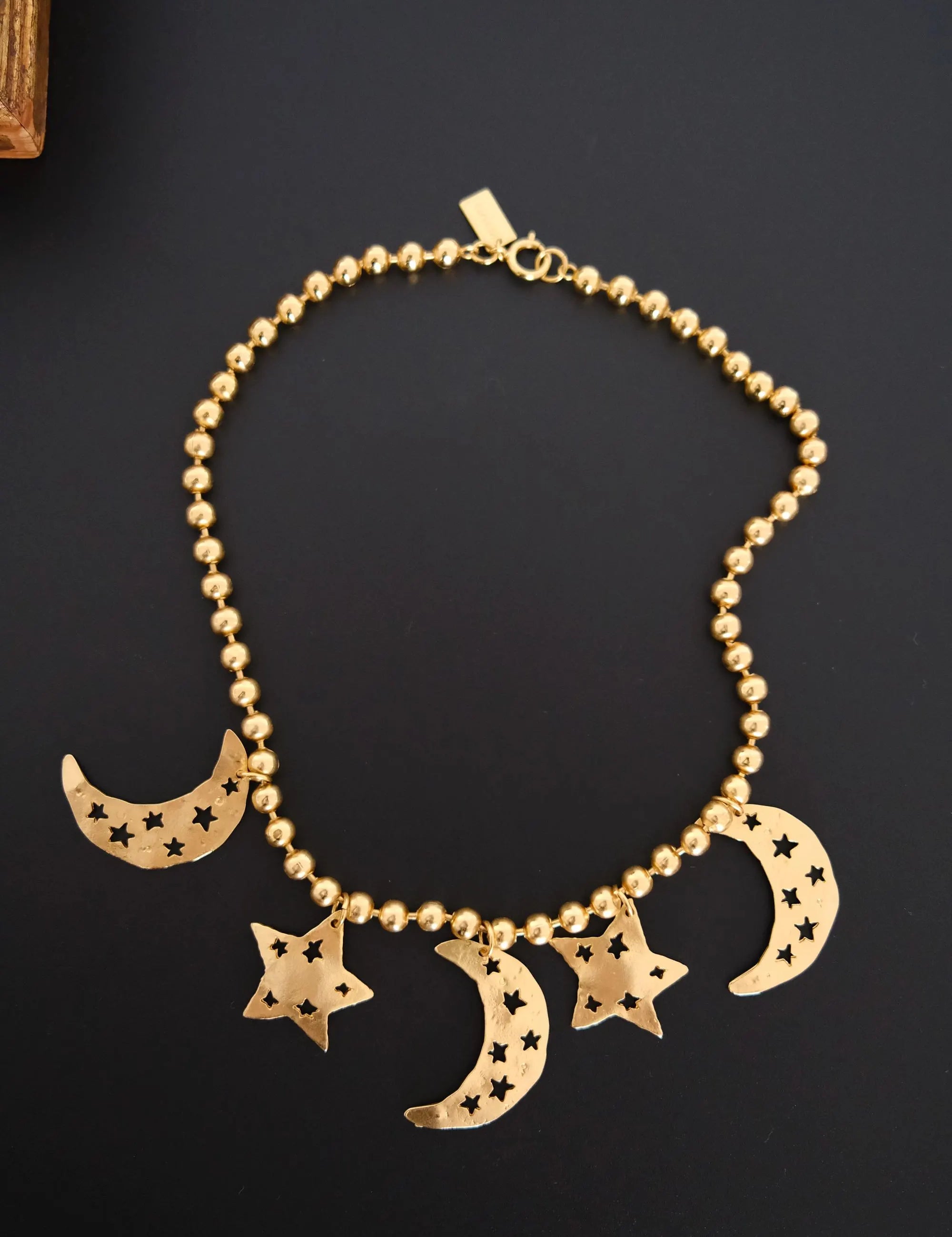 Vintage KENZO Paris gold-tone celestial charm necklace with dangling crescent moon and star pendants