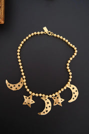 Vintage KENZO Paris gold-tone celestial charm necklace with dangling crescent moon and star pendants