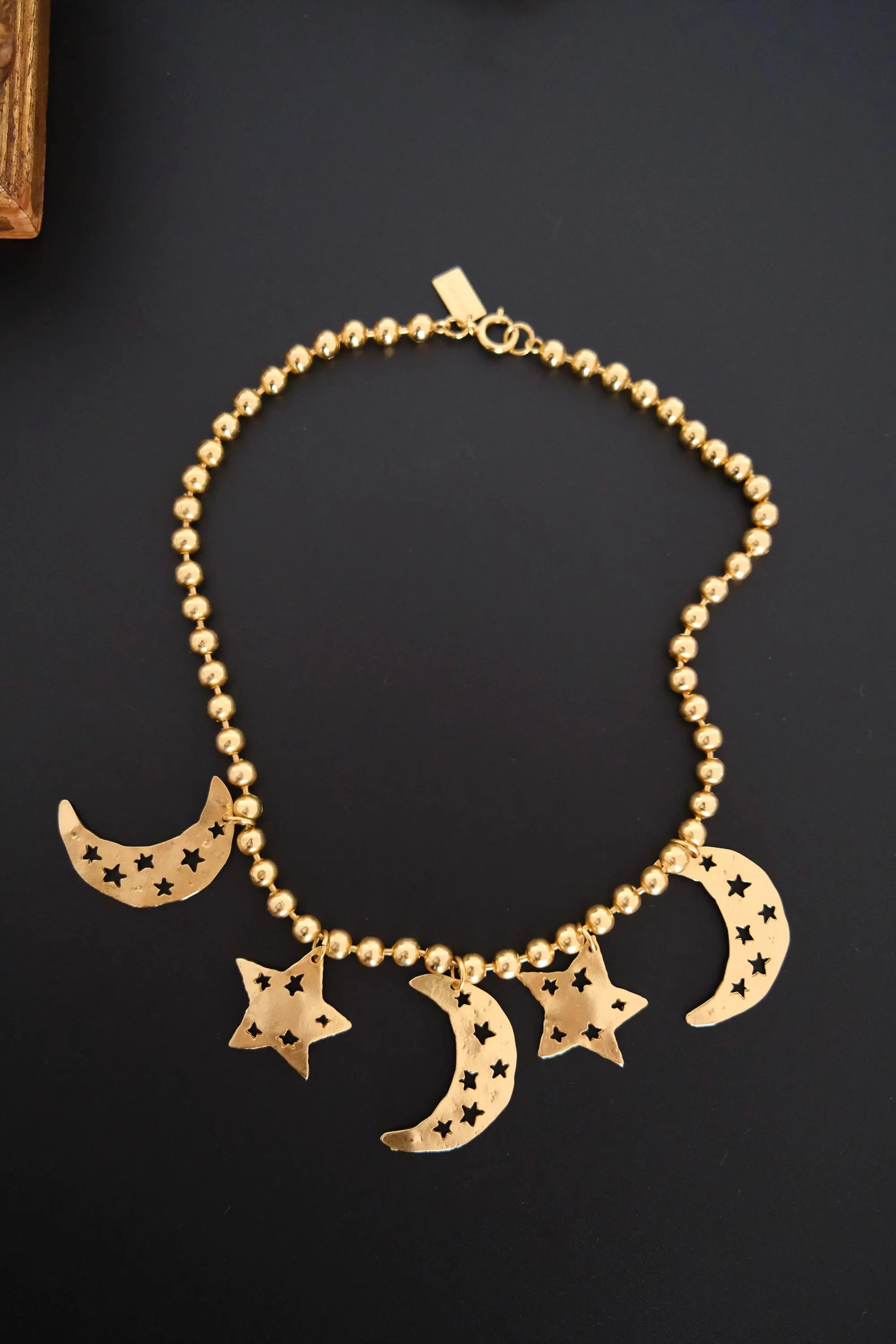 Vintage KENZO Paris gold-tone celestial charm necklace with dangling crescent moon and star pendants