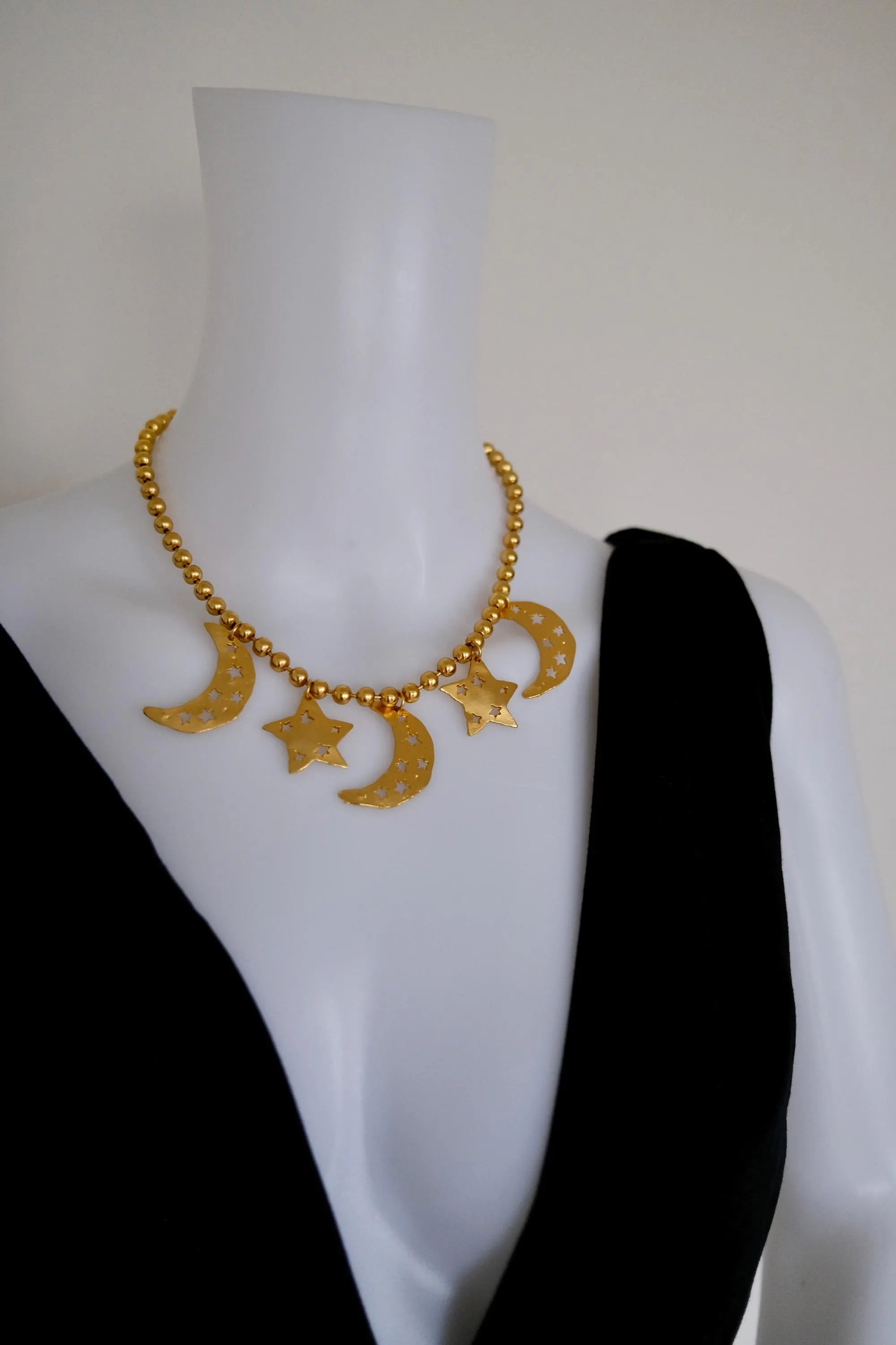 Vintage KENZO Paris gold-tone celestial charm necklace with dangling crescent moon and star pendants