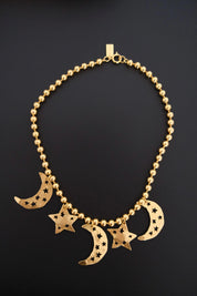 Vintage KENZO Paris gold-tone celestial charm necklace with dangling crescent moon and star pendants
