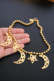 Vintage KENZO Paris gold-tone celestial charm necklace with dangling crescent moon and star pendants