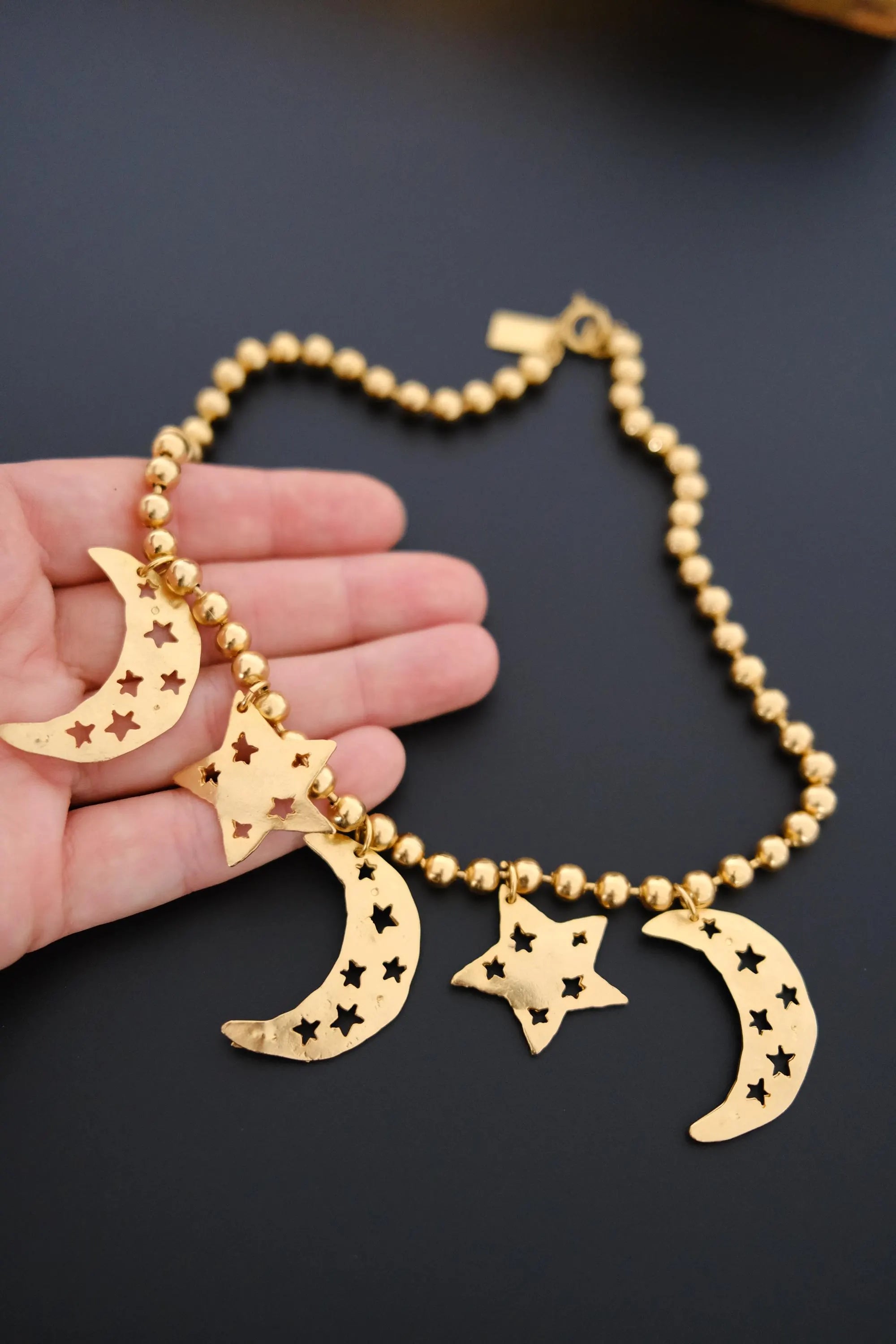 Vintage KENZO Paris gold-tone celestial charm necklace with dangling crescent moon and star pendants