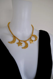 Vintage KENZO Paris gold-tone celestial charm necklace with dangling crescent moon and star pendants