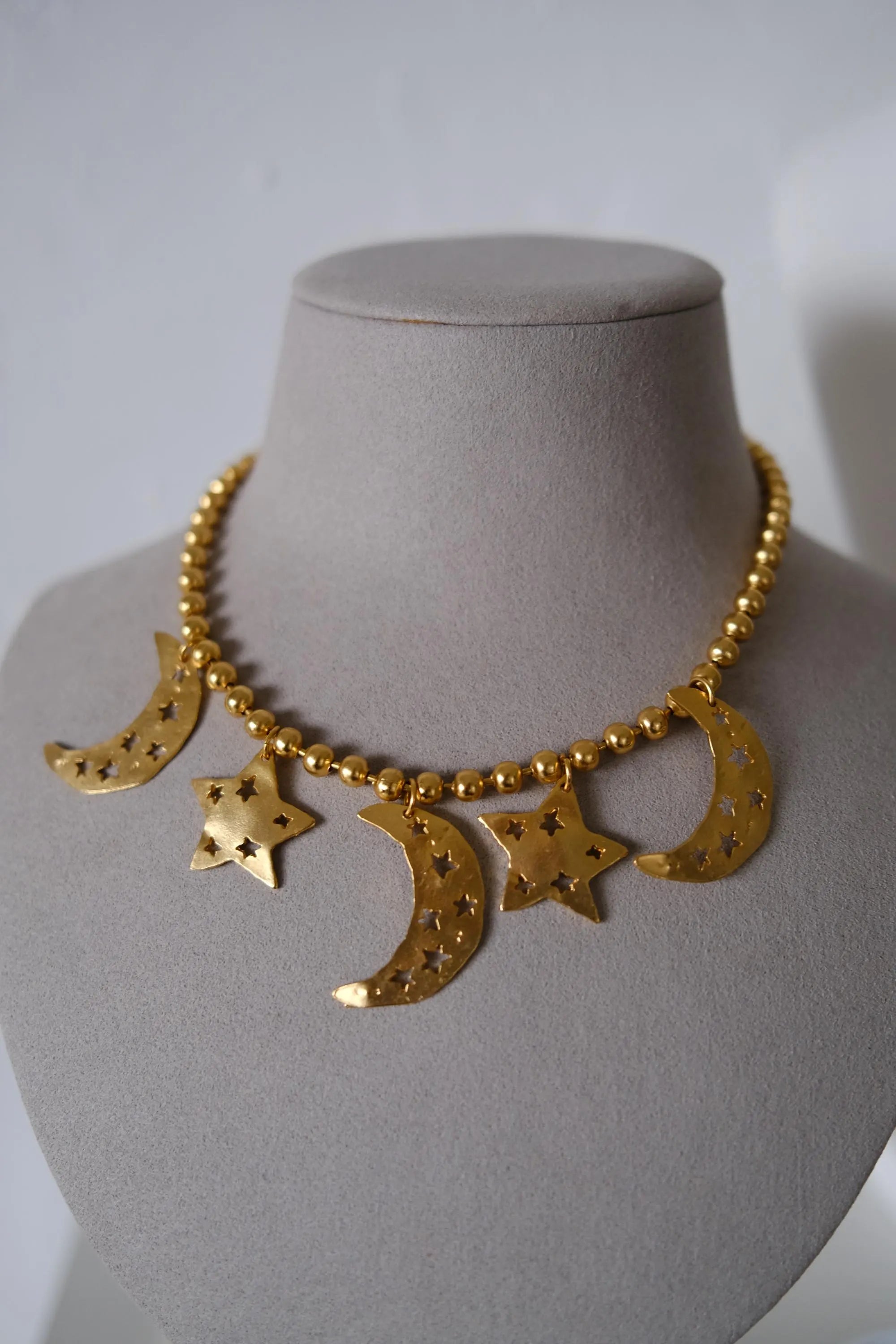 Vintage KENZO Paris gold-tone celestial charm necklace with dangling crescent moon and star pendants