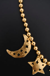 Vintage KENZO Paris gold-tone celestial charm necklace with dangling crescent moon and star pendants