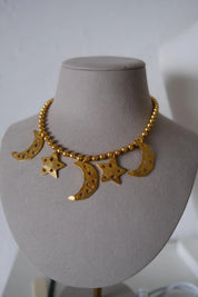 Vintage KENZO Paris gold-tone celestial charm necklace with dangling crescent moon and star pendants