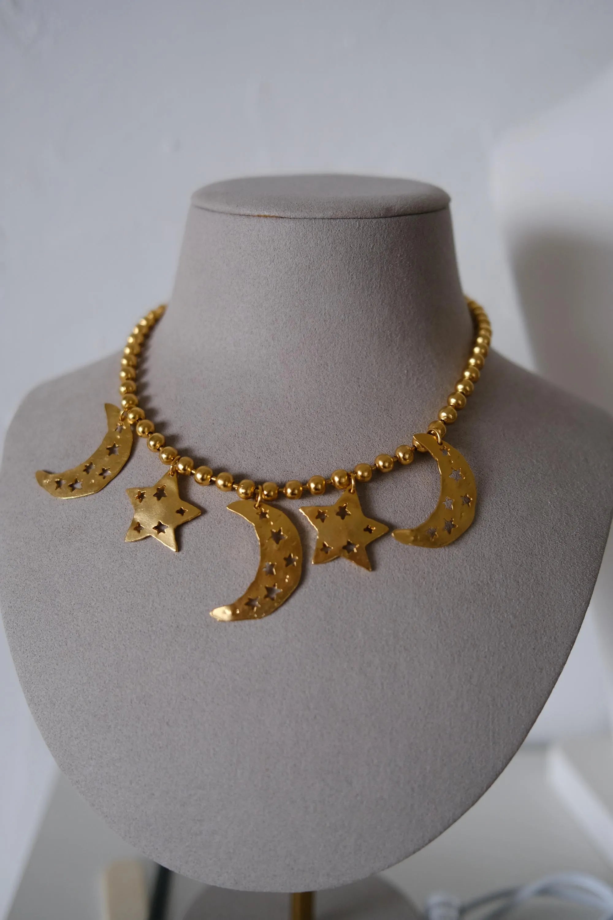 Vintage KENZO Paris gold-tone celestial charm necklace with dangling crescent moon and star pendants