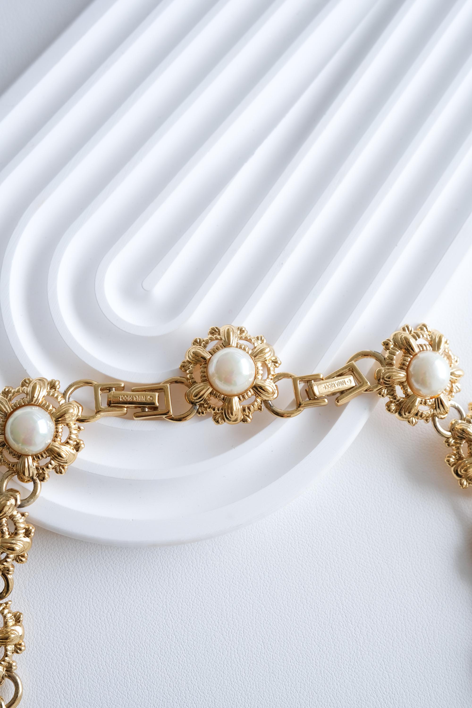 Nina Ricci floral pearl choker on neck Parisian chic elegant style