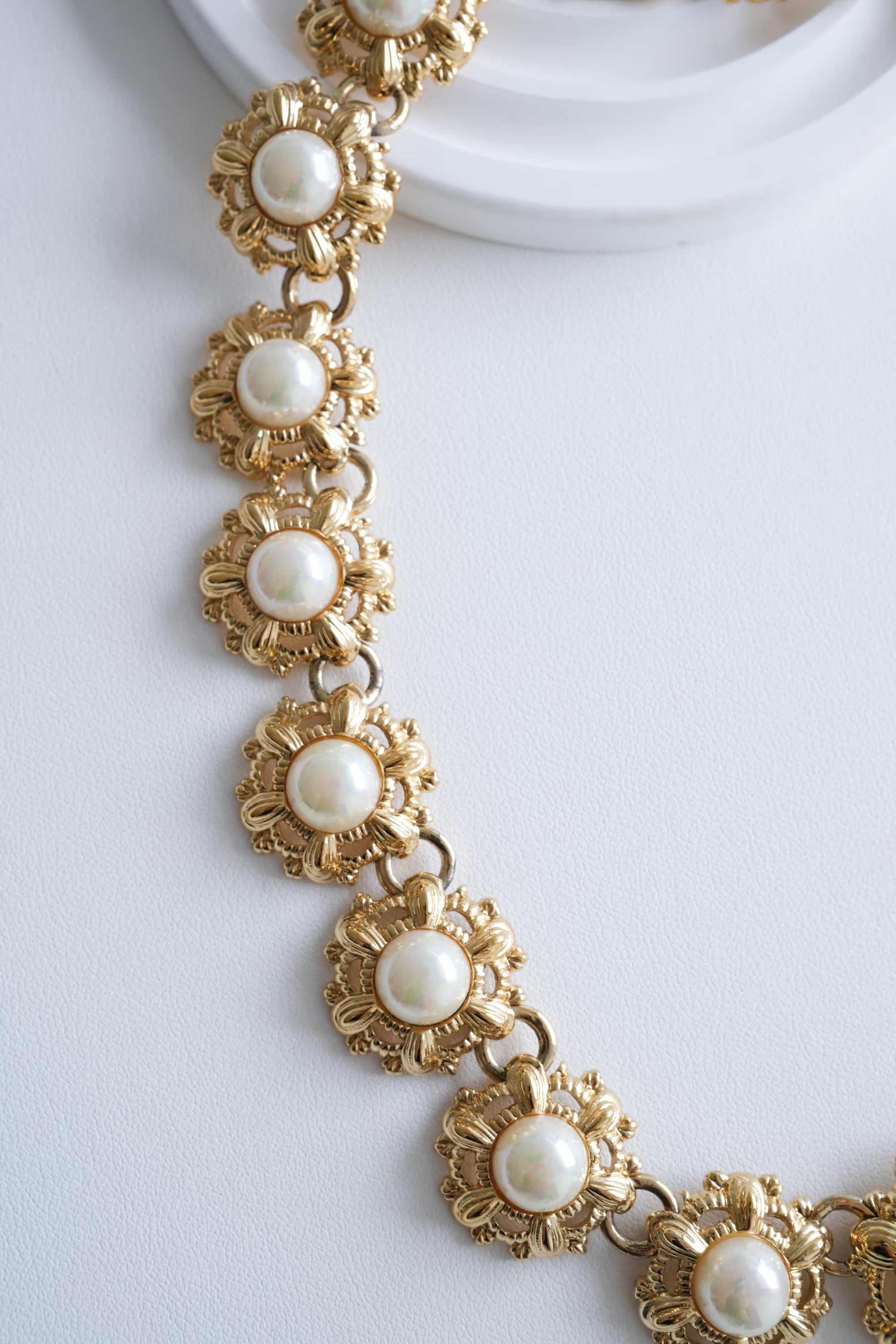 Nina Ricci floral pearl choker on neck Parisian chic elegant style