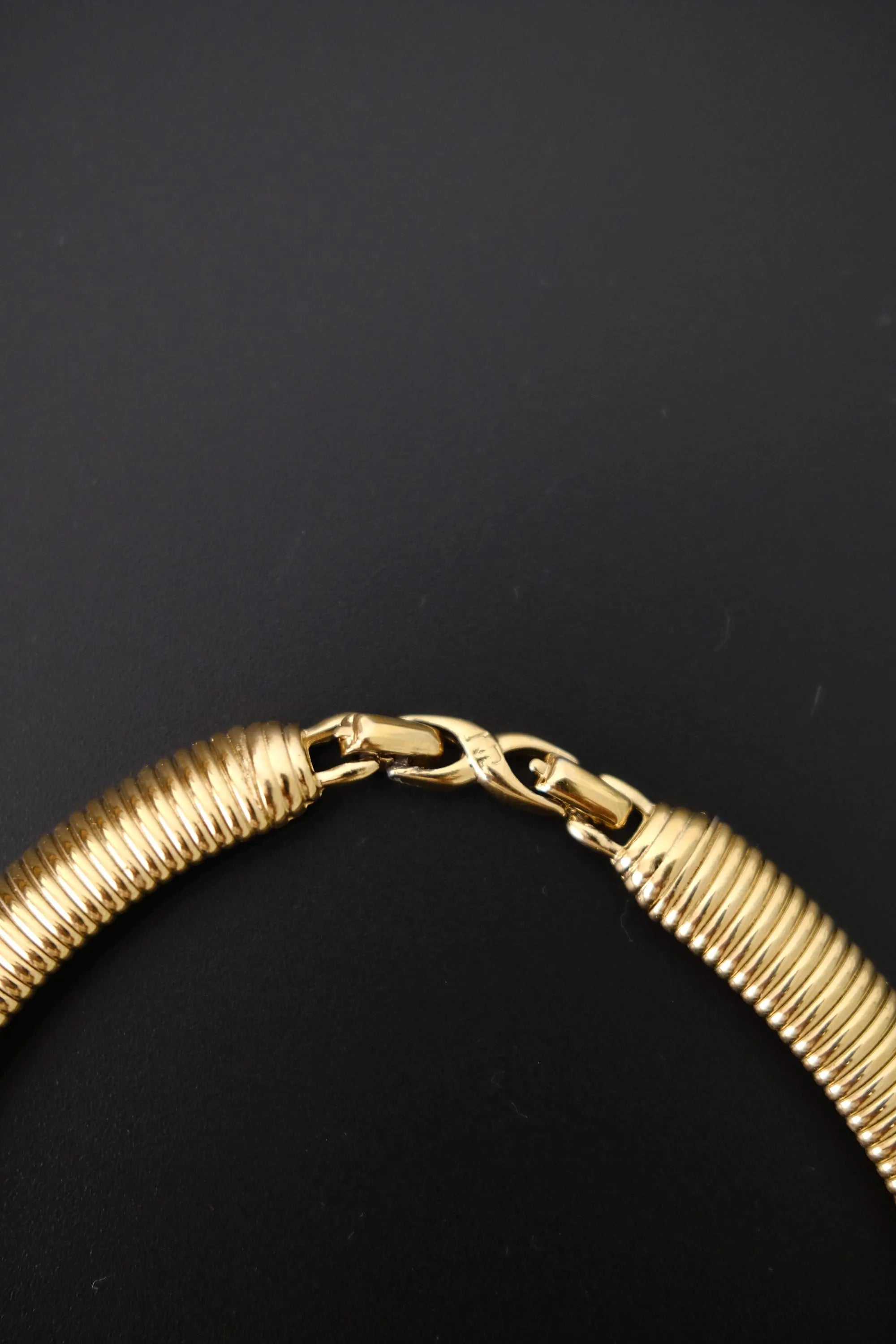 Close-up of hook closure on vintage Nina Ricci gold-tone Tubogas choker necklace