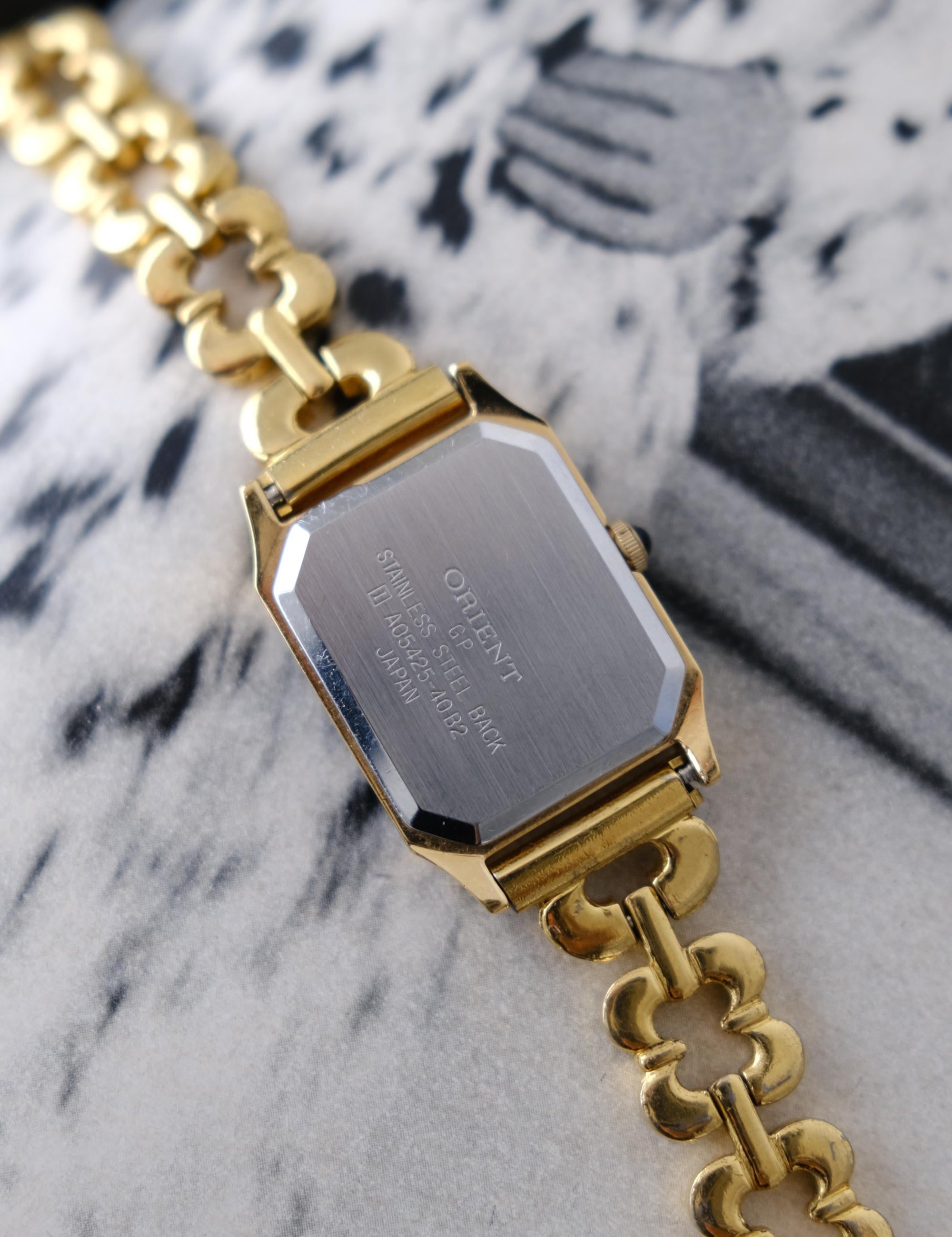 Back view of vintage ORIENT Japanese quartz watch with stainless steel case back